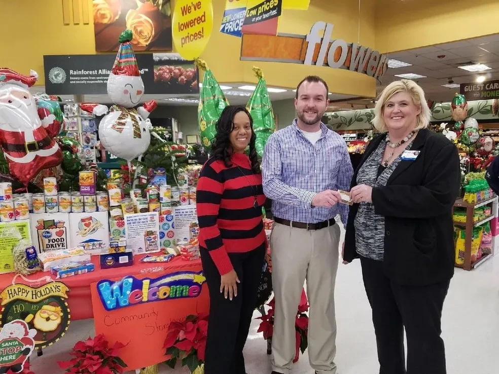 Community Storehouse team at a grocery store food drive event